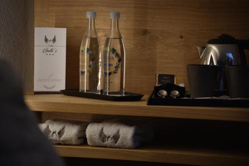two bottles sitting on top of a shelf with towels at Hotel Galli's - Centro in Livigno