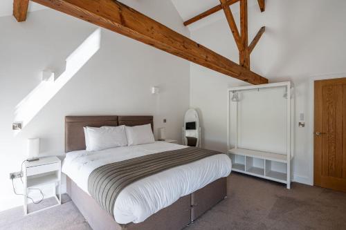 a bedroom with a large bed in a attic at The Old Chapel in Leyburn