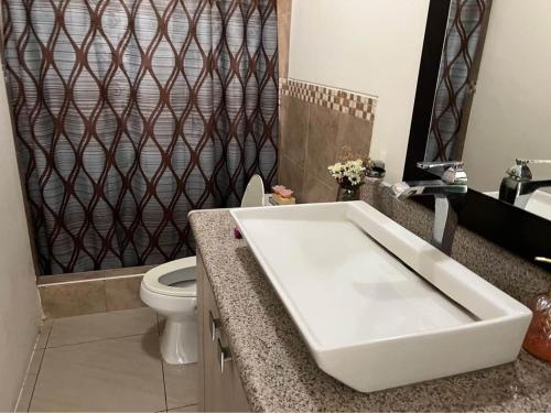 a bathroom with a white tub and a toilet at casa en samborondon in SamborondÃ³n