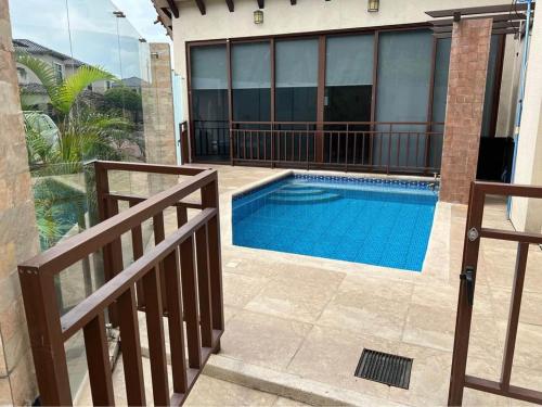 a swimming pool in front of a house at casa en samborondon in SamborondÃ³n