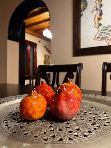 three pomegranates sitting on top of a table at The Knight and the Pomegranate - Luxury Medieval Villa in Rhodes Town