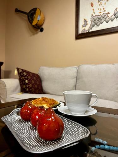 a coffee table with a plate of food and a cup at The Knight and the Pomegranate - Luxury Medieval Villa in Rhodes Town
