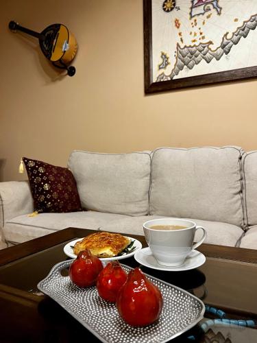 a coffee table with a plate of food and a cup of coffee at The Knight and the Pomegranate - Luxury Medieval Villa in Rhodes Town