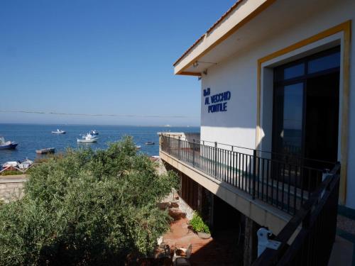 a balcony of a hotel with a view of the ocean at Al Vecchio Pontile bed and breakfast in Marsala
