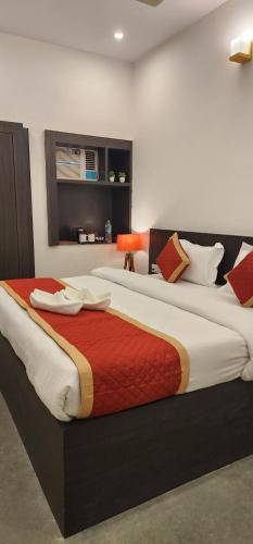 a bedroom with two large beds in a room at Green Club Farm in Ajmer