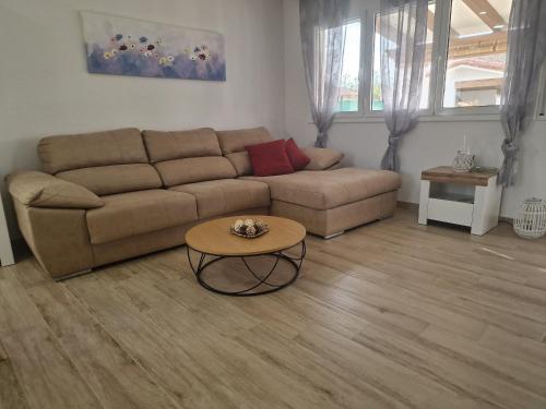a living room with a couch and a table at Riumar Sueno, 270m to beach, Privat-Pool, On-Site-Service, dog beach in Riumar