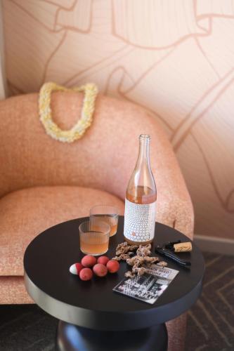 a table with a bottle on top of a chair at The Ambassador of Waikiki, Tapestry Collection by Hilton in Honolulu