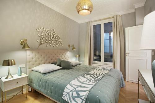 a bedroom with a bed with a zebra print bedspread at Résidence Opéra by Studio prestige in Paris