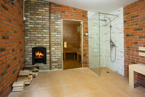 a bathroom with a fireplace and a walk in shower at Комплекс Златна Кошута 