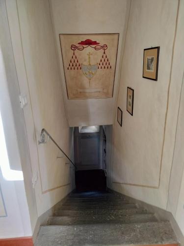 a stairway with a painting on the ceiling at Foresteria San Niccolò in Prato