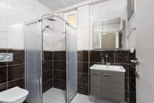 a bathroom with a shower and a toilet and a sink at Villa Sasha 2 in Ortaca
