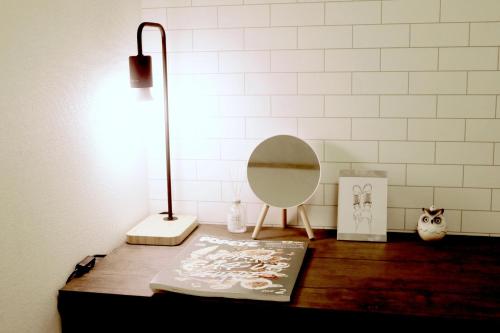 a table with a lamp and a mirror on it at Daiichi Mitsumi Corporation - Vacation STAY 15350 in Musashino