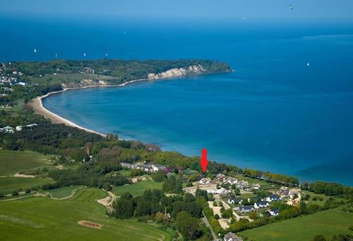 an island with a red marker in the water at Strandvilla "Babette" - BALO A, direkt am Meer, mit Sauna in Lobbe