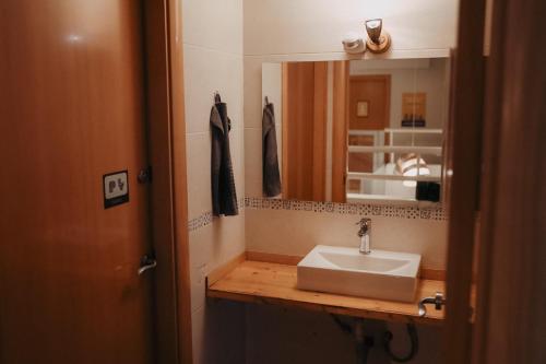 a bathroom with a sink and a mirror at Onefam Batlló in Barcelona