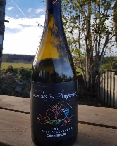 a bottle of wine sitting on a table at Terre d'Horizon Auvergne in Chastreix