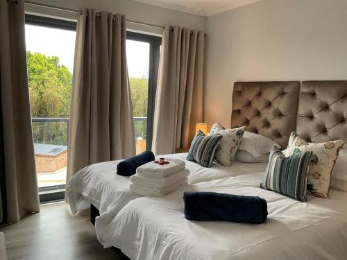 a bedroom with two beds with pillows and a window at Bond Self-Catering Unit in Knysna