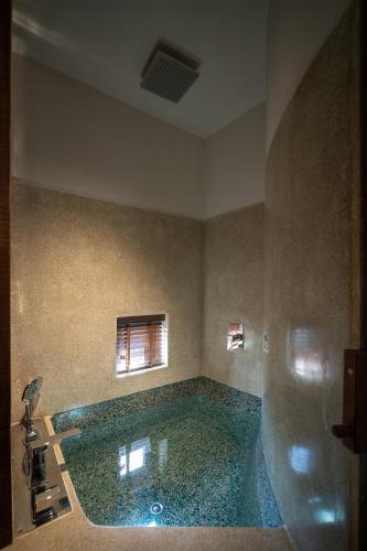 a bathroom with a large pool of water at Mùa Dalat Wellness Hotel in Da Lat