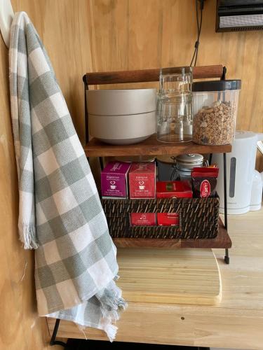 a towel hanging on a shelf with food items at Minimalist Cabin Solo Traveller in Ashburton