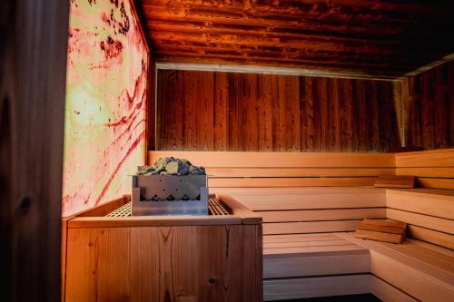 a wooden sauna with a laptop sitting in it at Bursztynowe Resort&SPA Stegna in Stegna