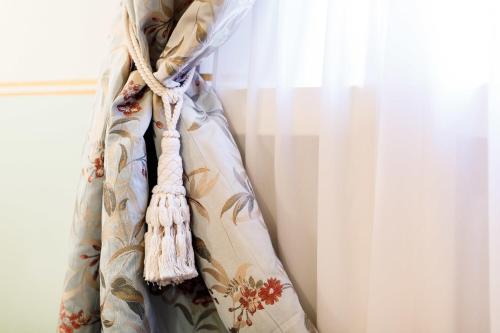 a curtain is hanging next to a window at B&B Al Re in Cesena