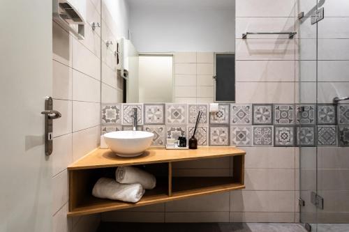a bathroom with a sink and a shower at Zeus Temple view 2BD Apartment by UPSTREET in Athens
