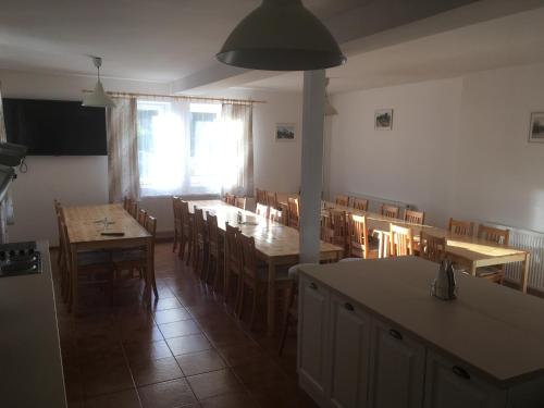 a dining room with wooden tables and chairs at U Čmeláka in Vyskeř