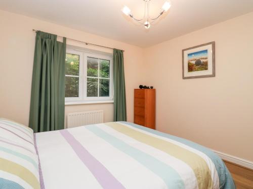 a bedroom with a bed and a window at Fell Haven in St Bees