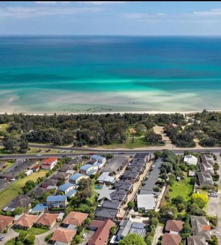 an aerial view of a city with houses and the ocean at BeachTownhouse779 in Rosebud