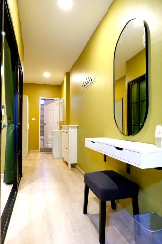 a bathroom with a sink and a mirror at BEB Silom Condolette in Bangkok