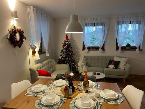 a living room with a christmas tree and a table at Chalet Jayata in Stará Lesná
