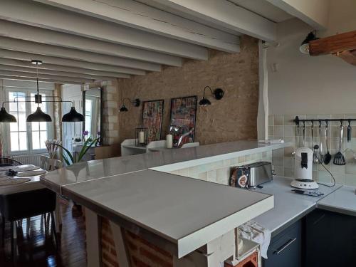 a kitchen with a white counter top in a room at Châteauroux centre superbe appart duplex terrasse in Châteauroux