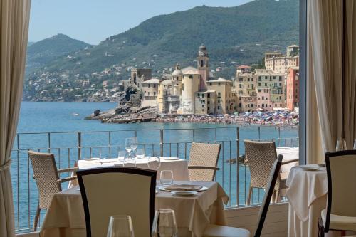 a restaurant with a view of the ocean and buildings at Hotel Cenobio Dei Dogi in Camogli