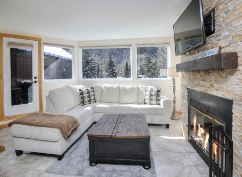 a living room with a couch and a fireplace at Pitkin Creek #7H in Vail