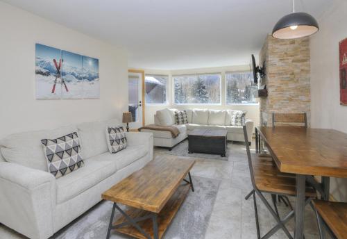 a living room with a couch and a table at Pitkin Creek #7H in Vail