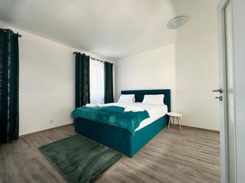 a bedroom with a bed and a table in it at Sky Apartments 502 in Plzeň