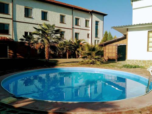 a large blue swimming pool in front of a building at Villa Dryanovo in Dryanovo