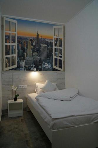 a white bedroom with a view of a city at Smart Hotel Rooms near metro 24/7 in Kyiv