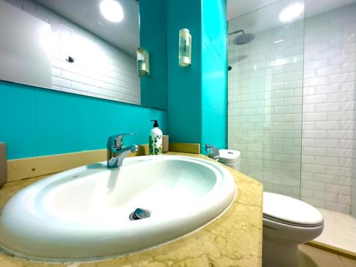 a bathroom with a sink and a toilet at Villa Rosa Atlantic Fuerteventura in Corralejo