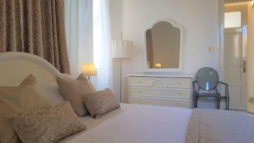 a bedroom with a bed and a dresser and a mirror at Apartment in Lovran 15142 in Lovran