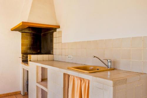 a kitchen with a sink and a stove at Son Peris in Caʼs Concos