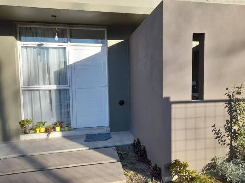 a front door of a house with a window at Yunka Alquiler temporario, Salta, Vaqueros in Vaqueros