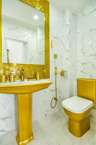a bathroom with a sink and a toilet and a mirror at Sera Boutique Hotel in Baku