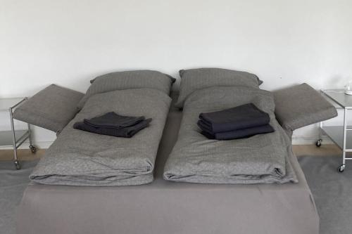 a bed with two pillows on top of it at River View Apartment in Hamburg