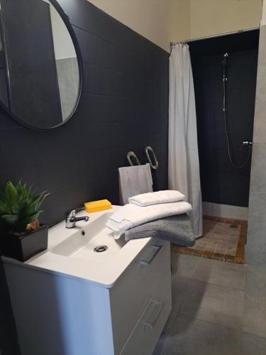 a bathroom with a white sink and a mirror at Appartements Luccisano in Borgo