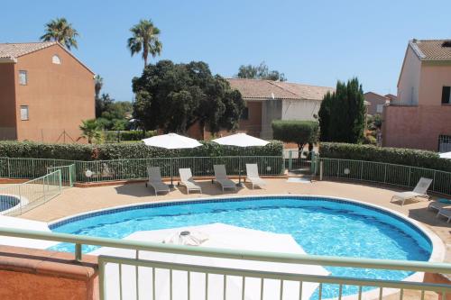 une grande piscine avec des chaises dans l'établissement Trilocale in residence con piscina a 200 m dal mare, à Linguizzetta