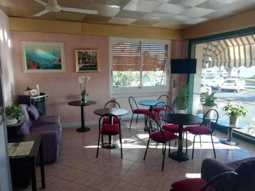 a restaurant with tables and chairs in a room at HOTEL GIORDANA in Loano