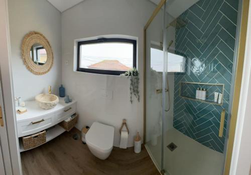 a bathroom with a shower and a toilet and a sink at Casa Sol in Lavra