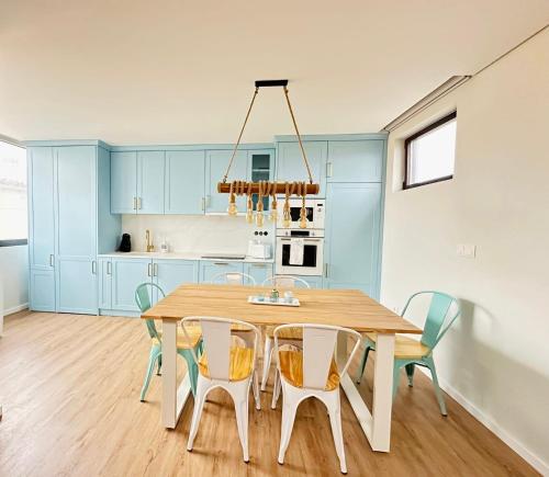 a dining room with a wooden table and chairs at Casa Sol in Lavra