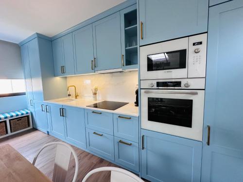 a kitchen with blue cabinets and a sink at Casa Sol in Lavra