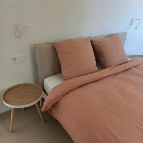 a bedroom with a bed with a table next to it at De Molenlos in Zottegem